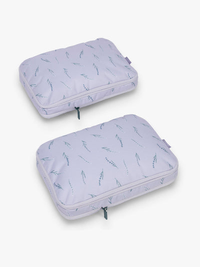 CALPAK Medium Compression Packing Cubes (Set of 2) compressed in light purple with lavender print in Lavender Bloom; PCC2201-LAVENDER-BLOOM