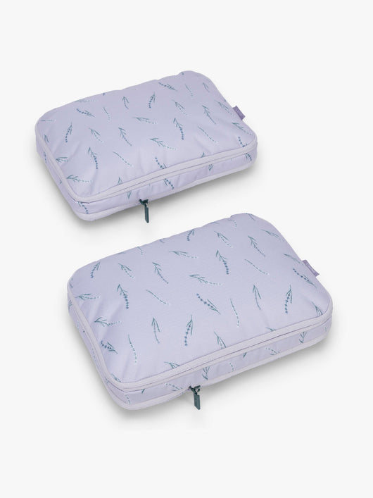 CALPAK Medium Compression Packing Cubes (Set of 2) compressed in light purple with lavender print in Lavender Bloom; PCC2201-LAVENDER-BLOOM