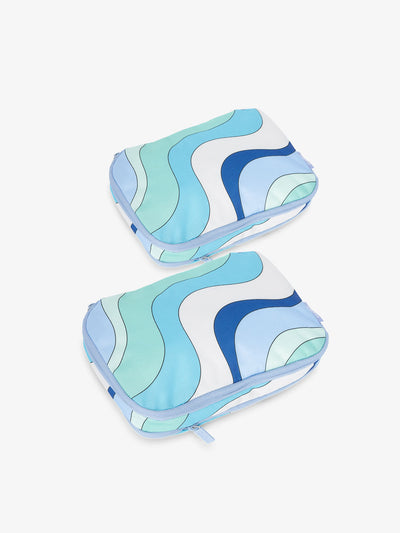 CALPAK small compression packing cubes in dark blue and light blue wavy print; PCS2301-GROOVY-BLUE