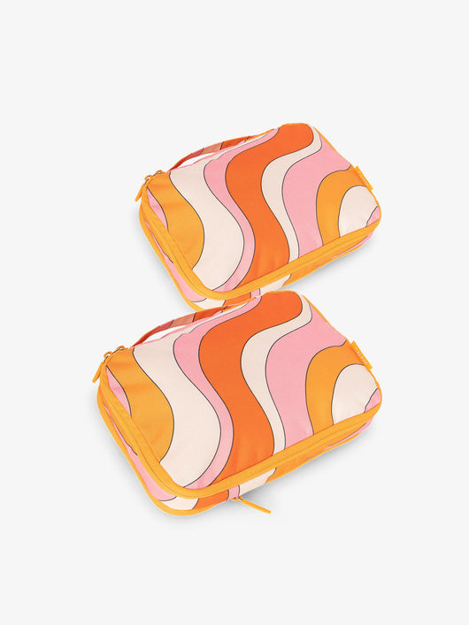 CALPAK small compression packing cubes in orange and pink wavy print; PCS2301-RETRO-SUNSET