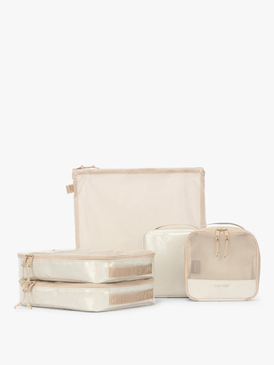 CALPAK Terra 5-Piece Packing Cube Set in off-white beige White Sands with two small cubes, two medium cubes, and one large mesh cube with zippers and mesh; PCT2601-WHITE-SANDS