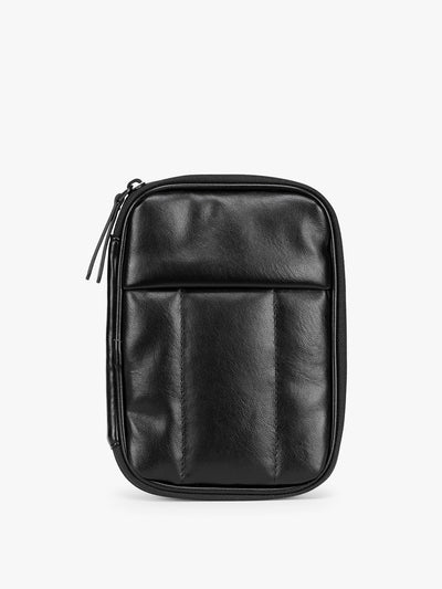  Black CALPAK Luka Zip Passport Wallet in vegan leather with a zippered top and a front pocket, shown on a plain white background; PZW2301-BLACK-PU