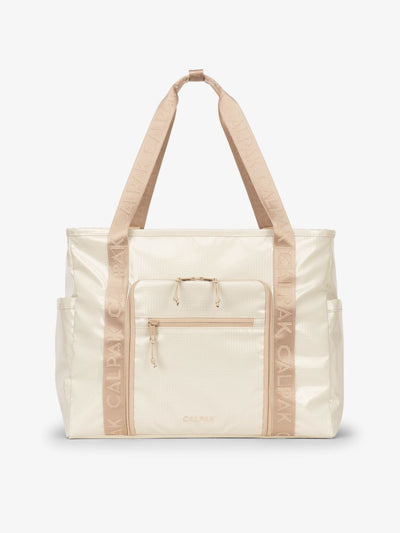 CALPAK Terra 35L Water Resistant Zippered Tote Bag made with durable recycled ripstop exterior, nylon webbing tote straps and multiple exterior pockets in white sands; TTO2401-WHITE-SANDS