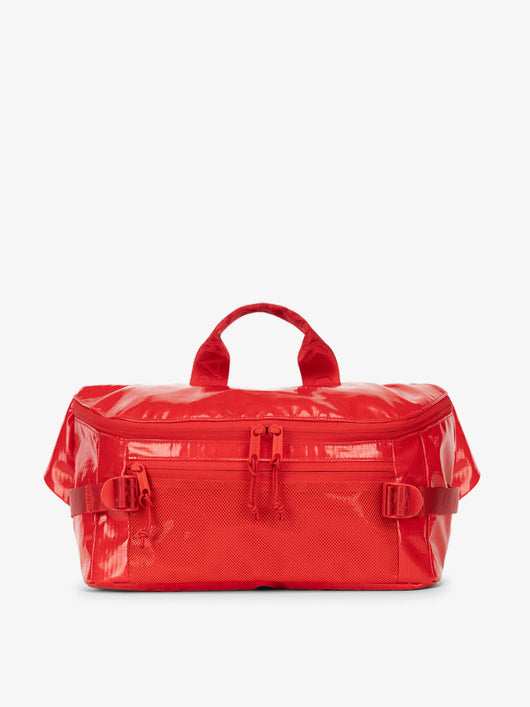 CALPAK Terra Sling Bag with mesh front pocket and top handle in red flame; CBH2201-FLAME