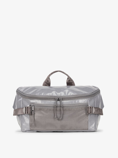 CALPAK Terra Sling Bag with mesh front pocket and top handle in gray storm; CBH2201-STORM