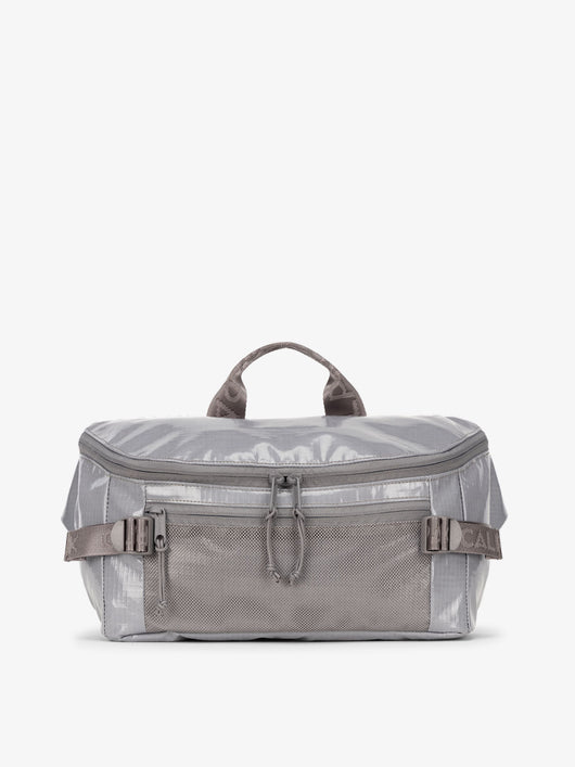 CALPAK Terra Sling Bag with mesh front pocket and top handle in gray storm; CBH2201-STORM