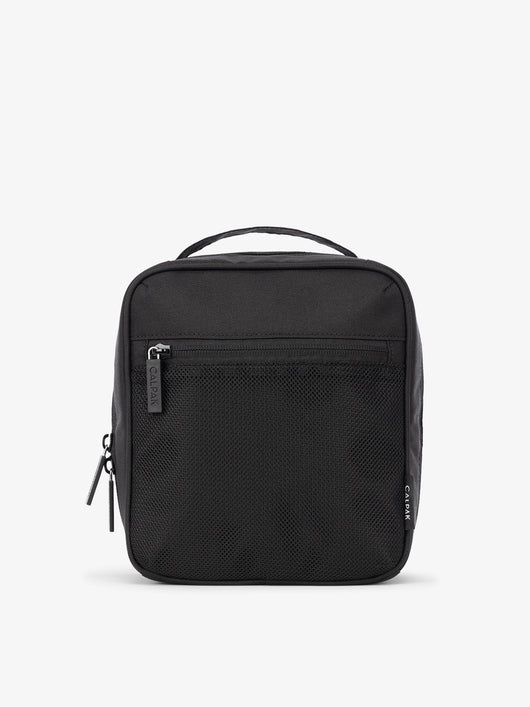 Front-view of CALPAK The Everything Cube made with durable exterior material featuring exterior mesh pocket and top handle in black; ACE2401-BLACK