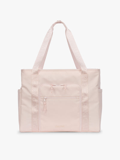 CALPAK Terra 35L Tote Bag with multiple pockets and shoulder straps in shiny light pink Shell Pink on a white background; TTO2401-SHELL-PINK