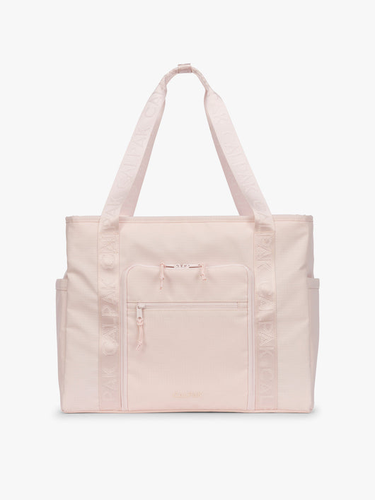 CALPAK Terra 35L Tote Bag with multiple pockets and shoulder straps in shiny light pink Shell Pink on a white background; TTO2401-SHELL-PINK