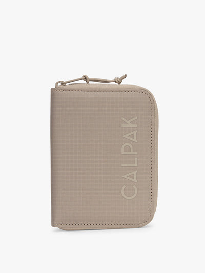 CALPAK Terra Zippered Passport Wallet in beige Stone front view; ATPW2501-STONE